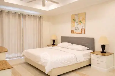 Spacious bedroom with elegant decor and natural light, featuring a comfortable bed and stylish furnishings.