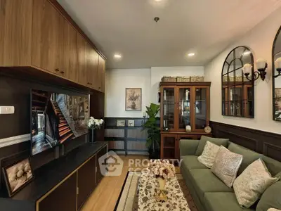 Elegant living room with stylish decor, wooden cabinets, and cozy seating area.