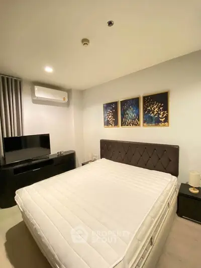 Modern bedroom with stylish decor and comfortable bed in a cozy apartment.
