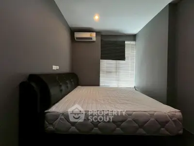 Modern bedroom with sleek design and air conditioning unit, perfect for comfort and relaxation.