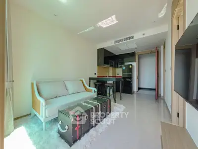 Modern living room with stylish furniture and open kitchen layout in a bright apartment.