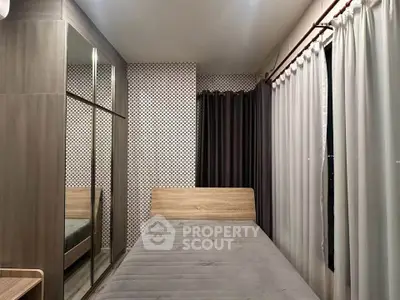 Modern bedroom with stylish decor and large mirrored wardrobe