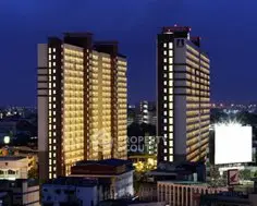 Stunning night view of illuminated high-rise buildings in a bustling cityscape.