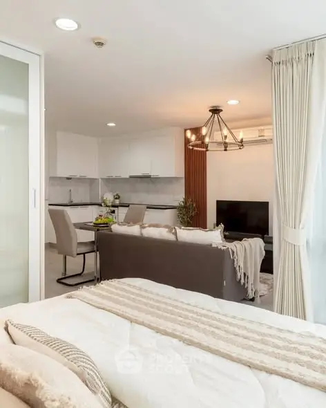 Modern open-plan living room and kitchen with elegant decor and cozy ambiance.