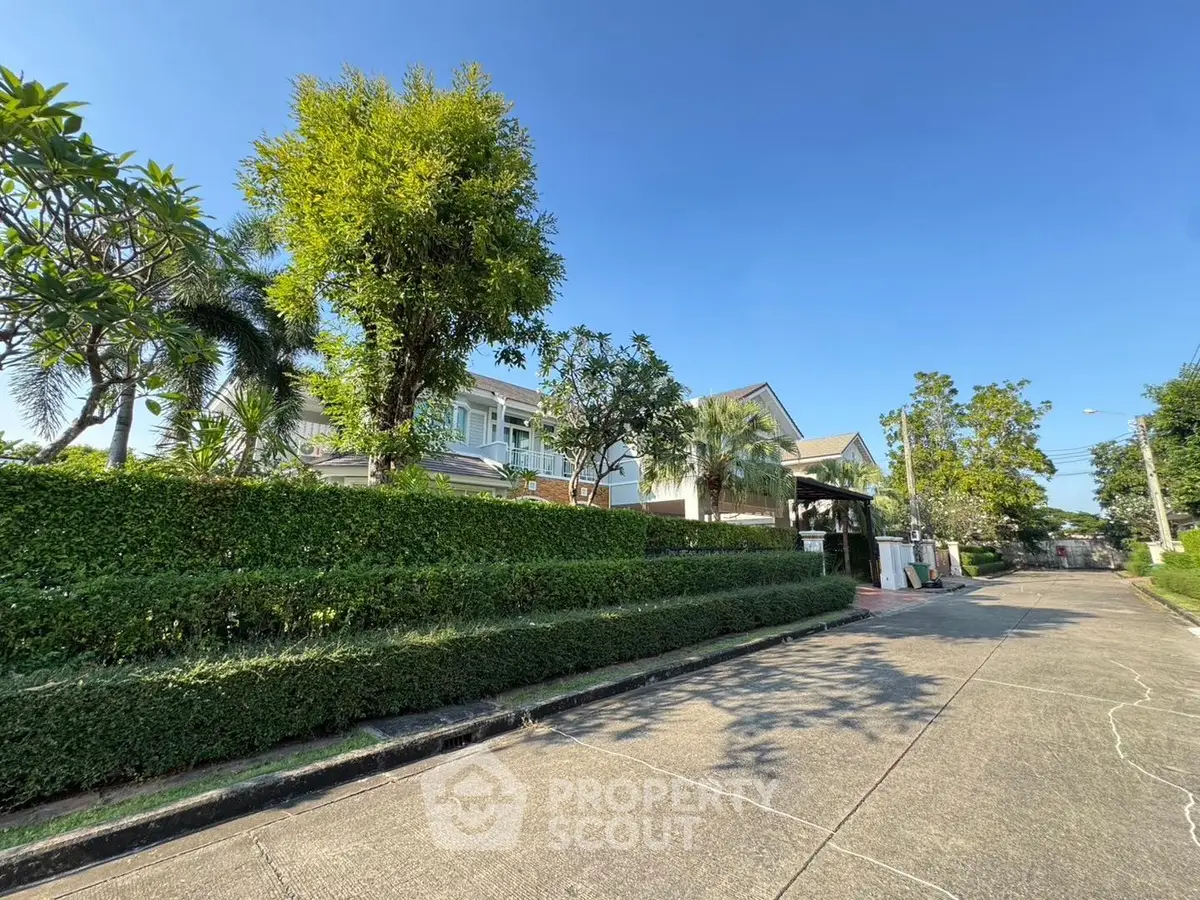 Charming suburban house with lush greenery and clear blue sky