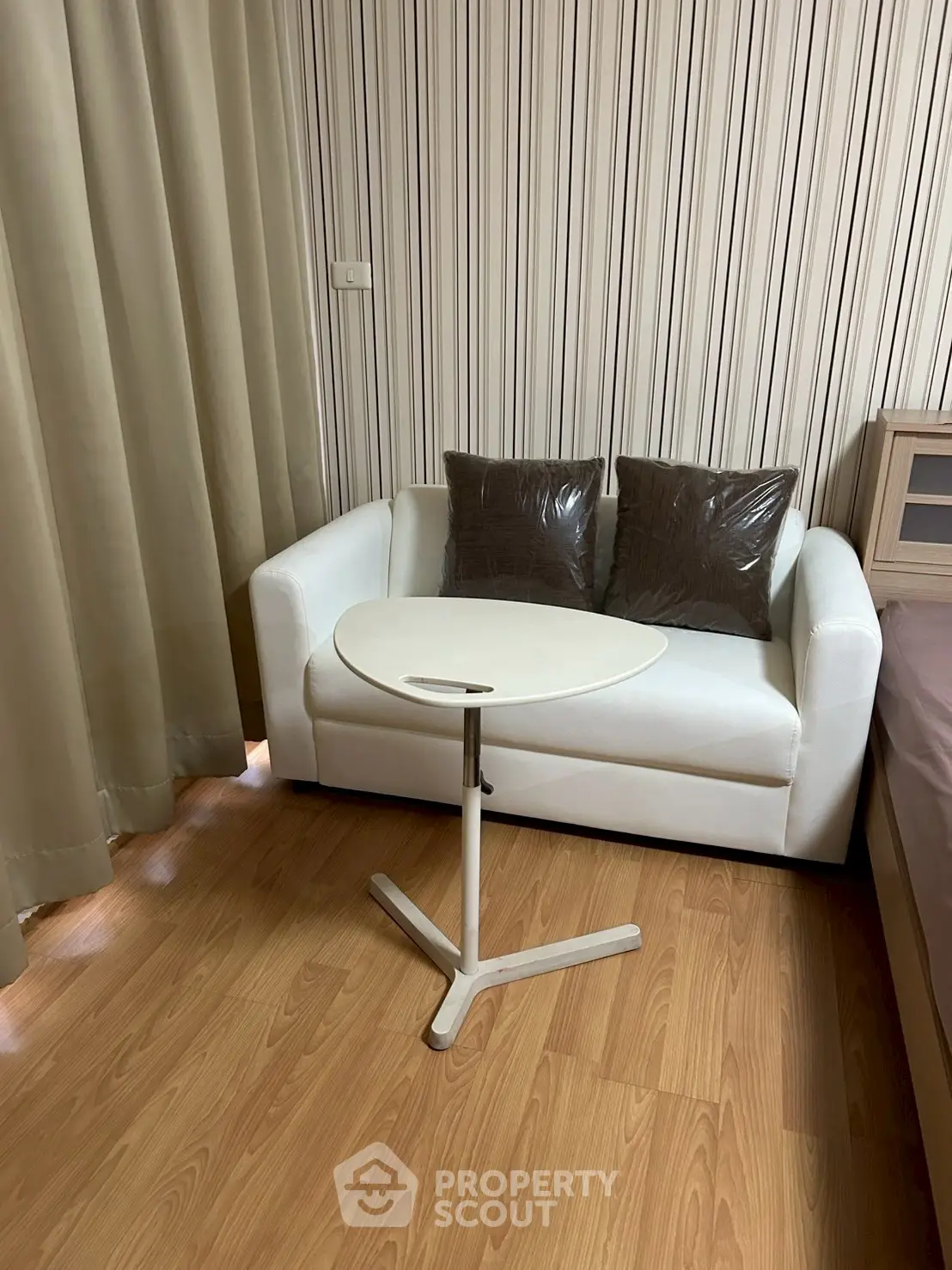Cozy small living area with white sofa and modern side table