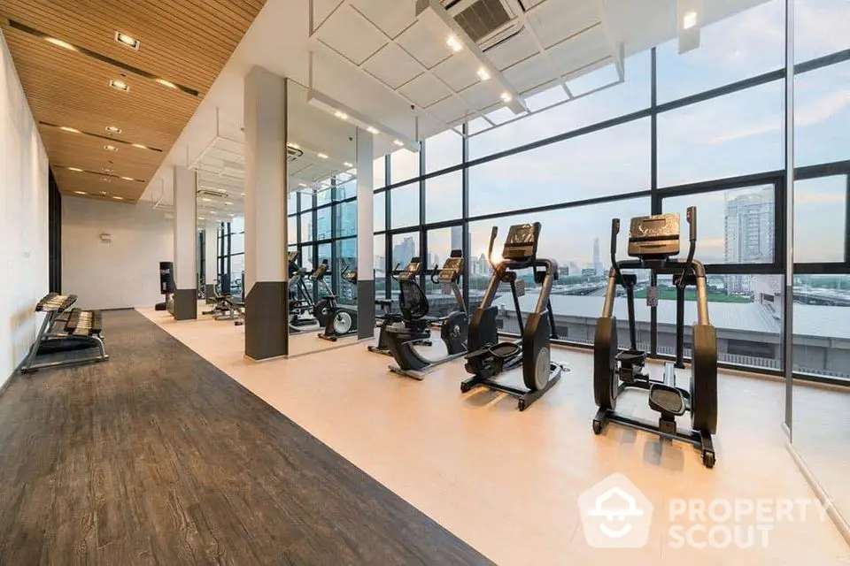 Spacious modern gym with panoramic city views and state-of-the-art equipment