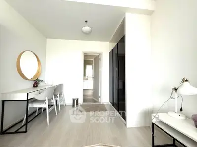 Modern minimalist bedroom with sleek furniture and large mirror