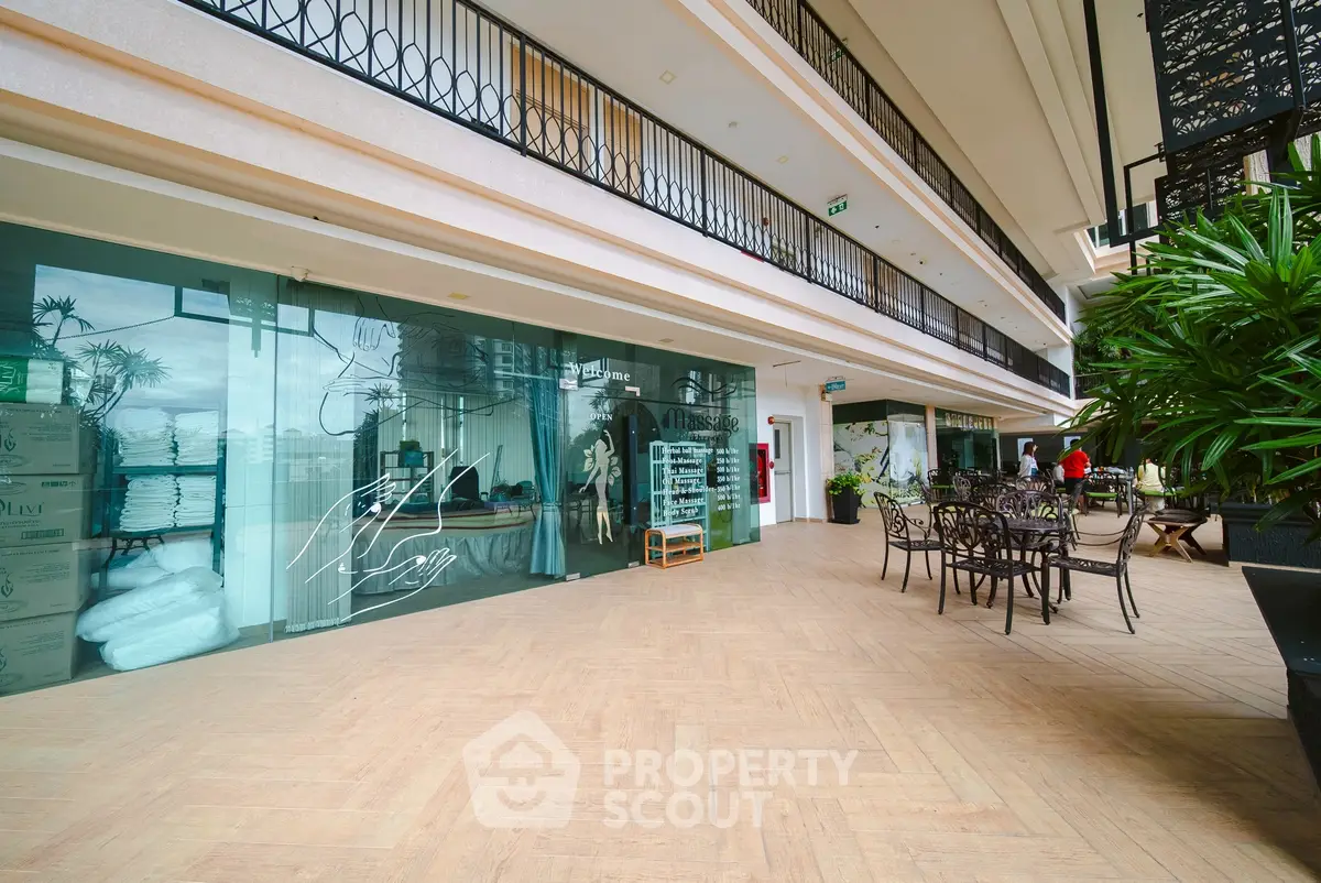 Spacious modern building interior with elegant design and outdoor seating area.