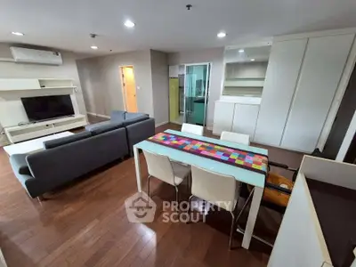 Spacious modern living room with sleek furniture and hardwood floors in a stylish apartment.