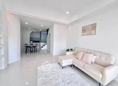 Modern living room with elegant white decor and cozy seating area
