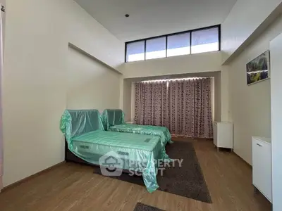 Spacious bedroom with modern design and large windows for natural light