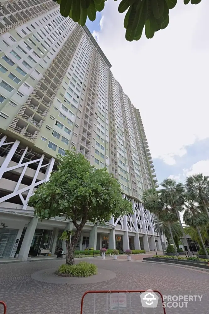 Stunning high-rise residential building with lush greenery and modern architecture.