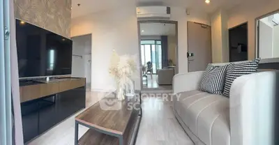 Modern living room with sleek design, featuring a cozy sofa and stylish decor.
