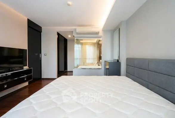Modern bedroom with sleek design and glass partition in luxury apartment