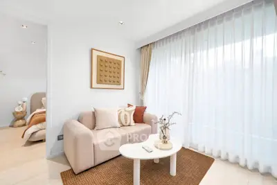 Elegant living room with cozy sofa and modern decor, perfect for relaxation.