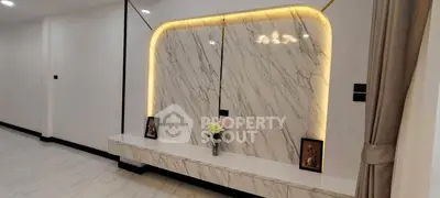 Elegant modern interior with marble wall and ambient lighting, perfect for luxury living.