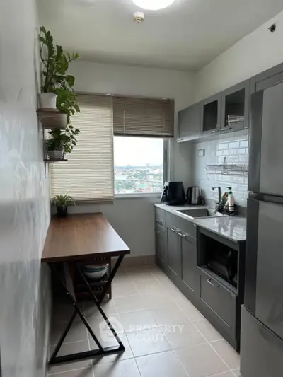Modern kitchen with sleek cabinets and city view window