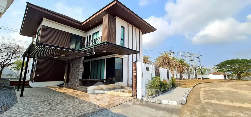 Modern two-story house with sleek design and spacious driveway in a serene neighborhood.