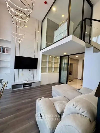 Luxurious modern living room with high ceilings and elegant lighting in a stylish apartment.
