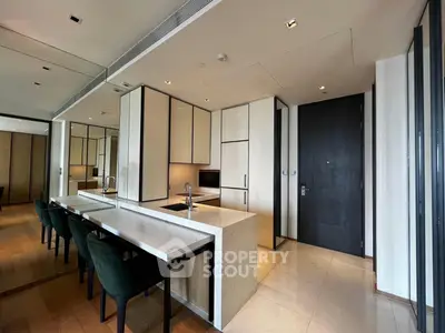 Luxurious modern kitchen with sleek design and open layout, featuring elegant dining area and high-end finishes.