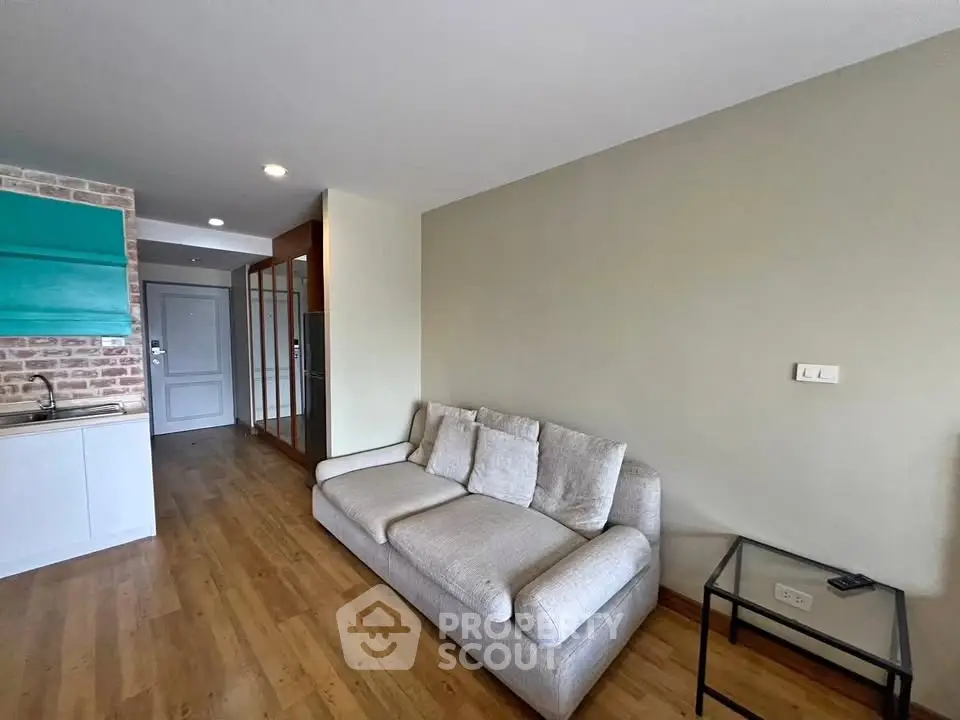 Modern living room with cozy sofa and stylish decor in open layout apartment.