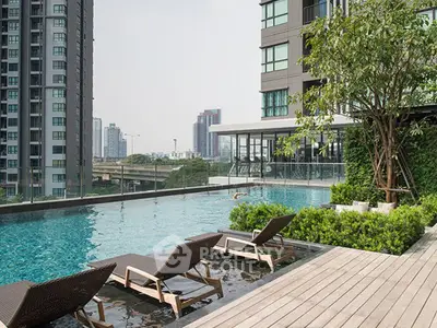 Luxurious rooftop pool with city skyline view in modern high-rise building.