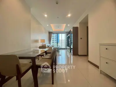 Spacious modern living room with dining area and city view, featuring elegant furniture and bright lighting.