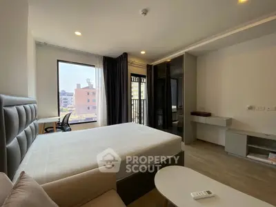 Modern bedroom with large windows and stylish furnishings in urban apartment