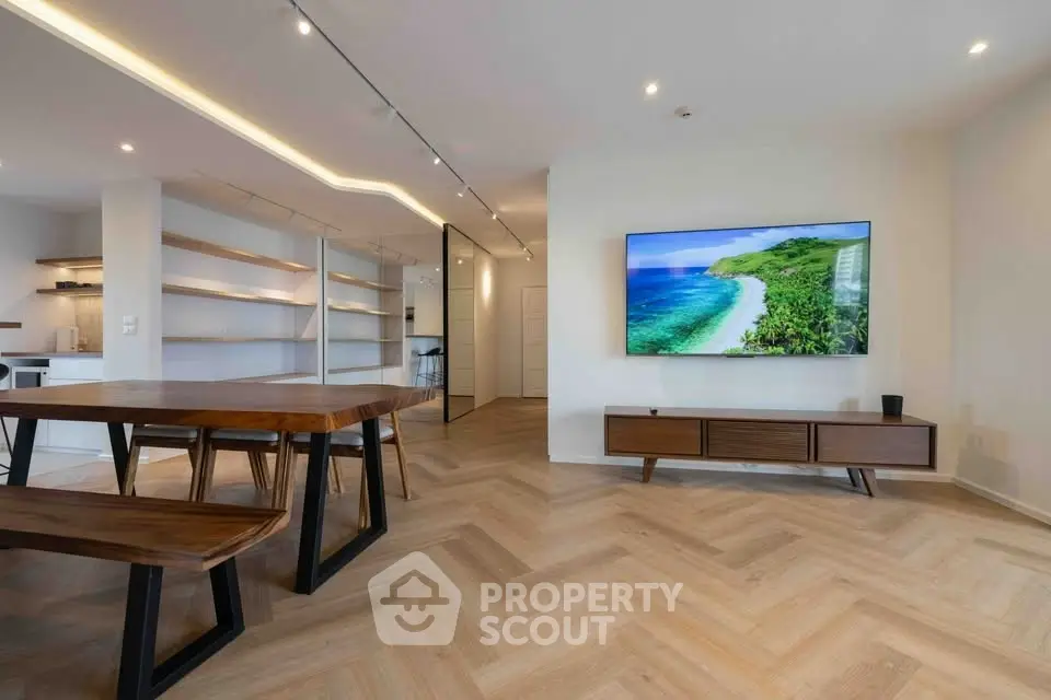 Modern living room with stylish wooden furniture and large wall-mounted TV