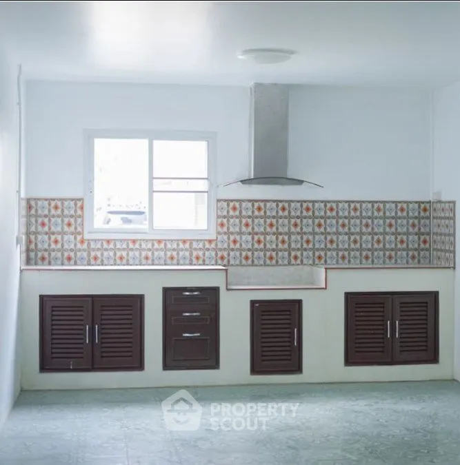 Charming kitchen with vintage tile backsplash and ample cabinet space.
