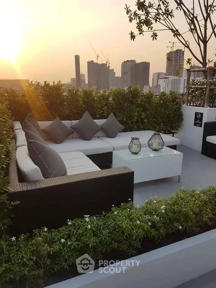 Stunning rooftop terrace with modern seating and city skyline view at sunset.