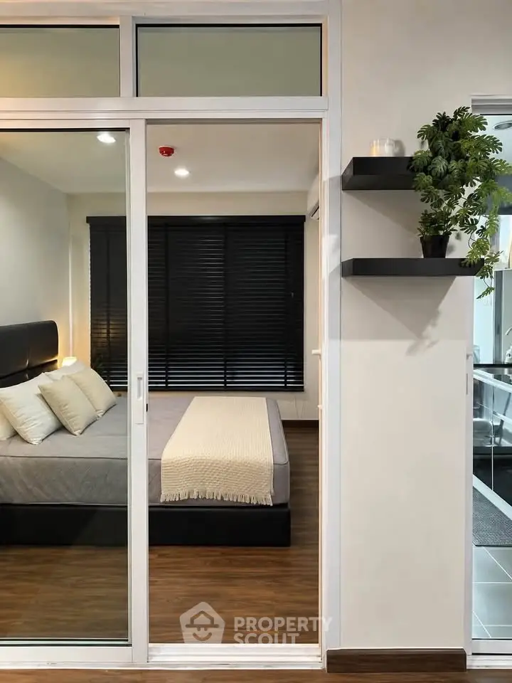 Modern bedroom with sliding glass doors and stylish decor