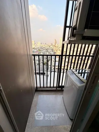 Compact balcony with washing machine and city view, perfect for urban living.