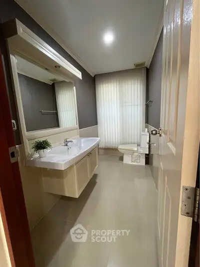 Spacious modern bathroom with elegant fixtures and natural light
