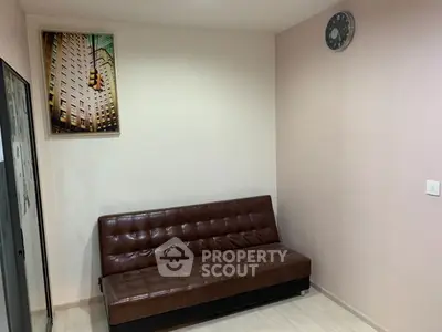 Cozy living room with brown leather sofa and modern wall art