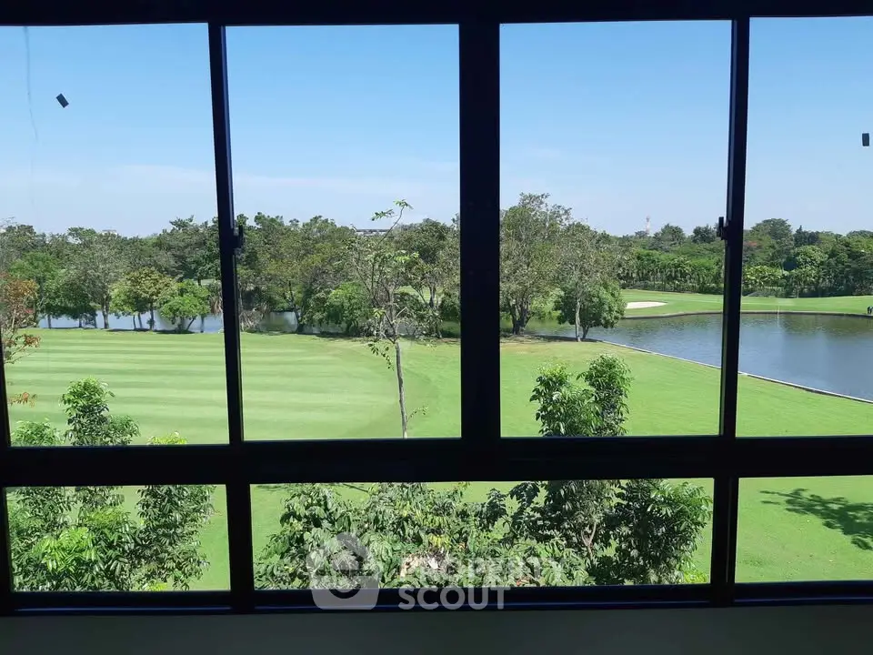 Stunning golf course view from large window in luxury property.