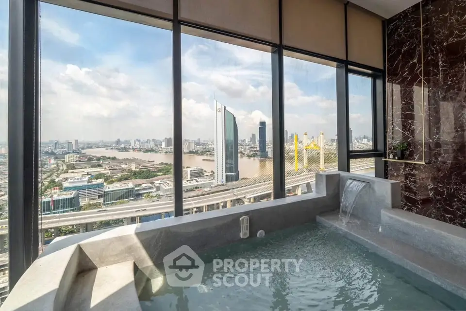 Luxurious high-rise apartment with stunning city and river views from a private indoor pool.