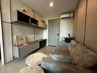 Modern living room with stylish furniture and wall-mounted storage in a cozy apartment.