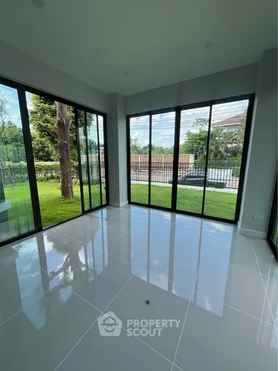 Spacious corner unit with large windows offering a serene garden view, perfect for natural light lovers.
