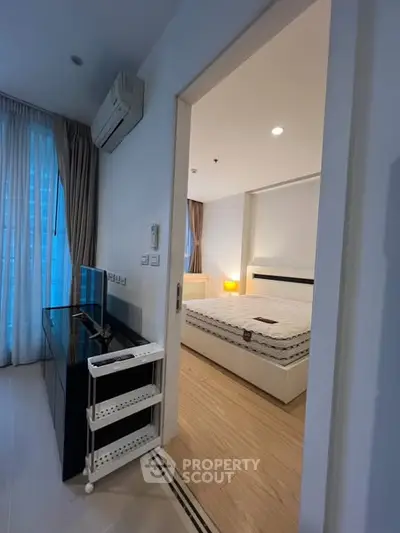 Modern bedroom with sleek furniture and natural light, featuring a comfortable bed and stylish decor.