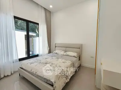 Modern bedroom with large window and elegant decor