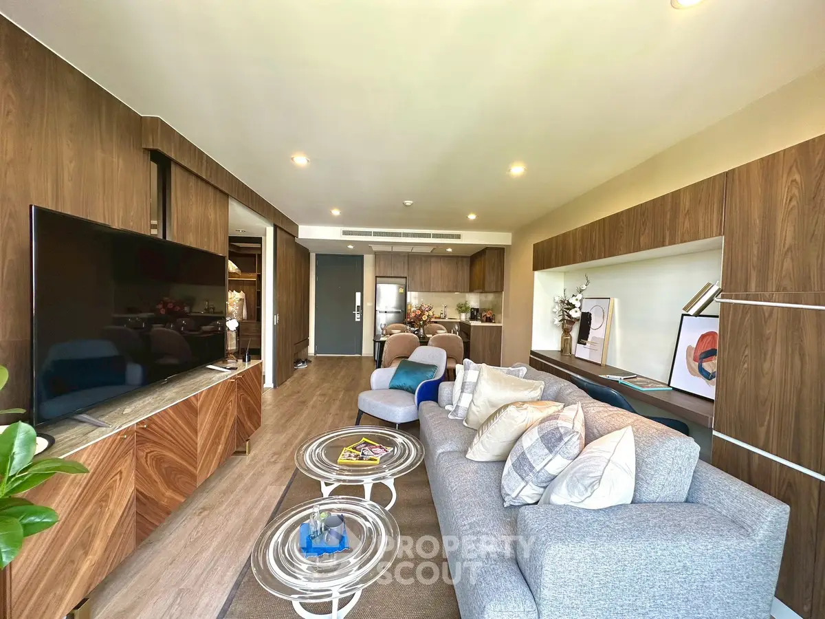 Spacious modern living room with elegant decor and open kitchen layout, perfect for entertaining.