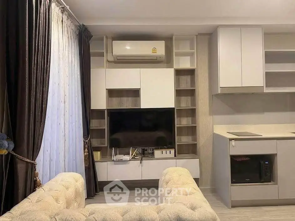 Modern living room with built-in entertainment center and cozy seating area.