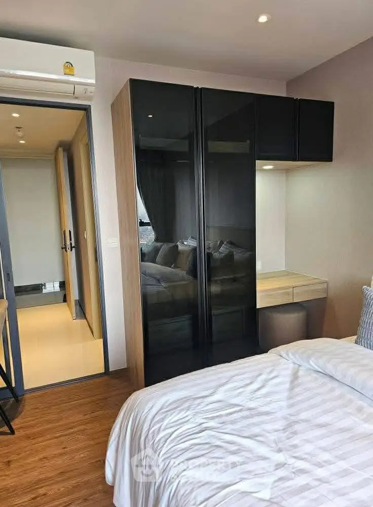 Modern bedroom with sleek wardrobe and cozy ambiance