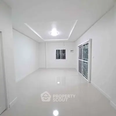 Spacious empty room with glossy tiled floor and bright lighting