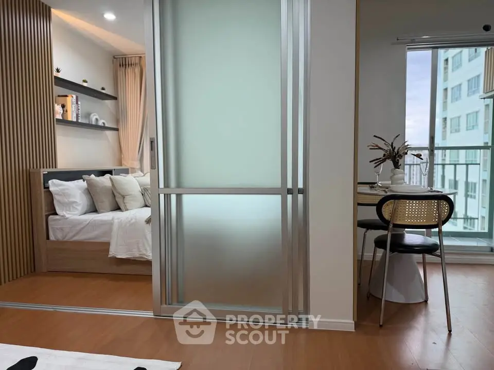 Modern apartment with sliding glass doors, cozy bedroom, and dining area with city view.