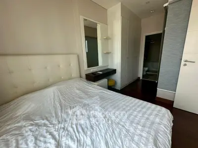 Modern bedroom with stylish decor and ensuite bathroom in a contemporary apartment.