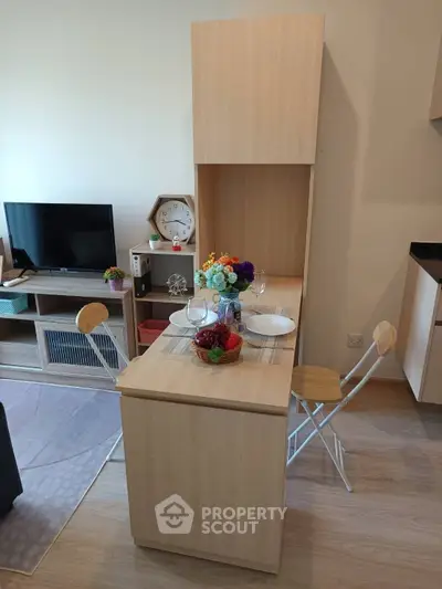 Modern living room with stylish dining area and TV setup, perfect for cozy gatherings.