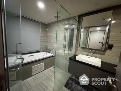 Luxurious modern bathroom with glass shower and sleek bathtub